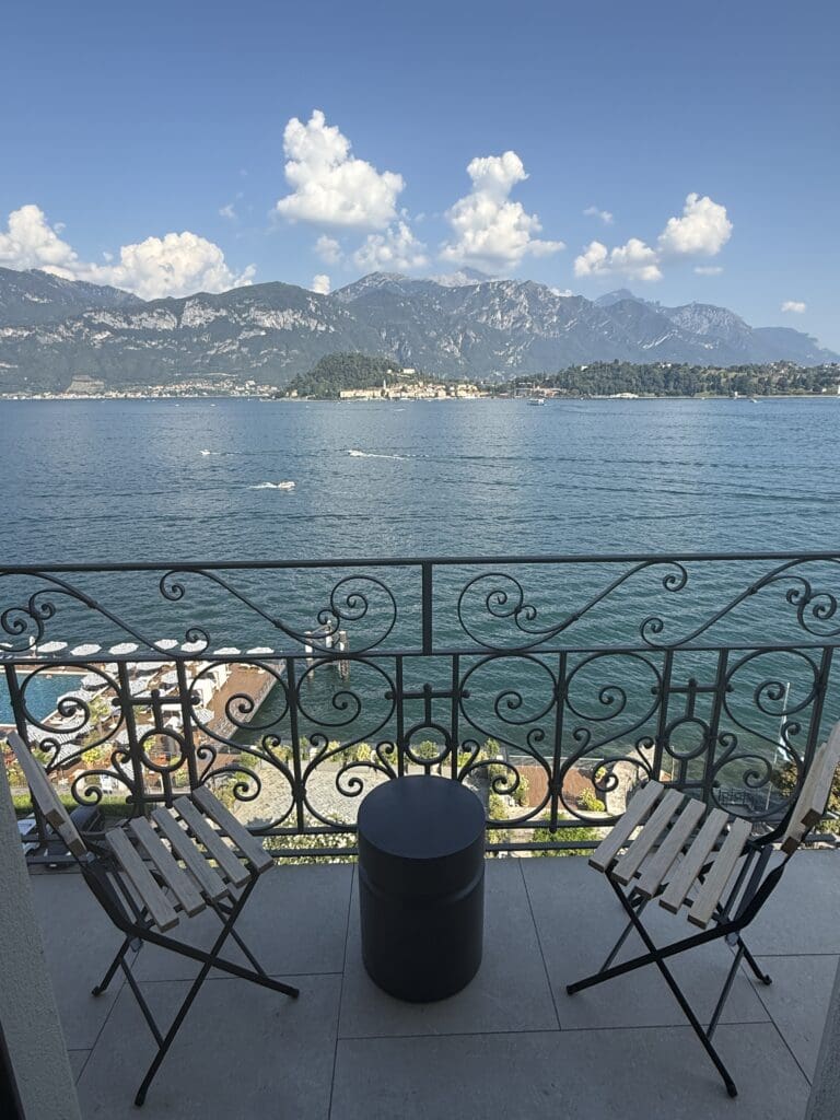 Lake Como view through the hotel's wrought-iron balcony railing